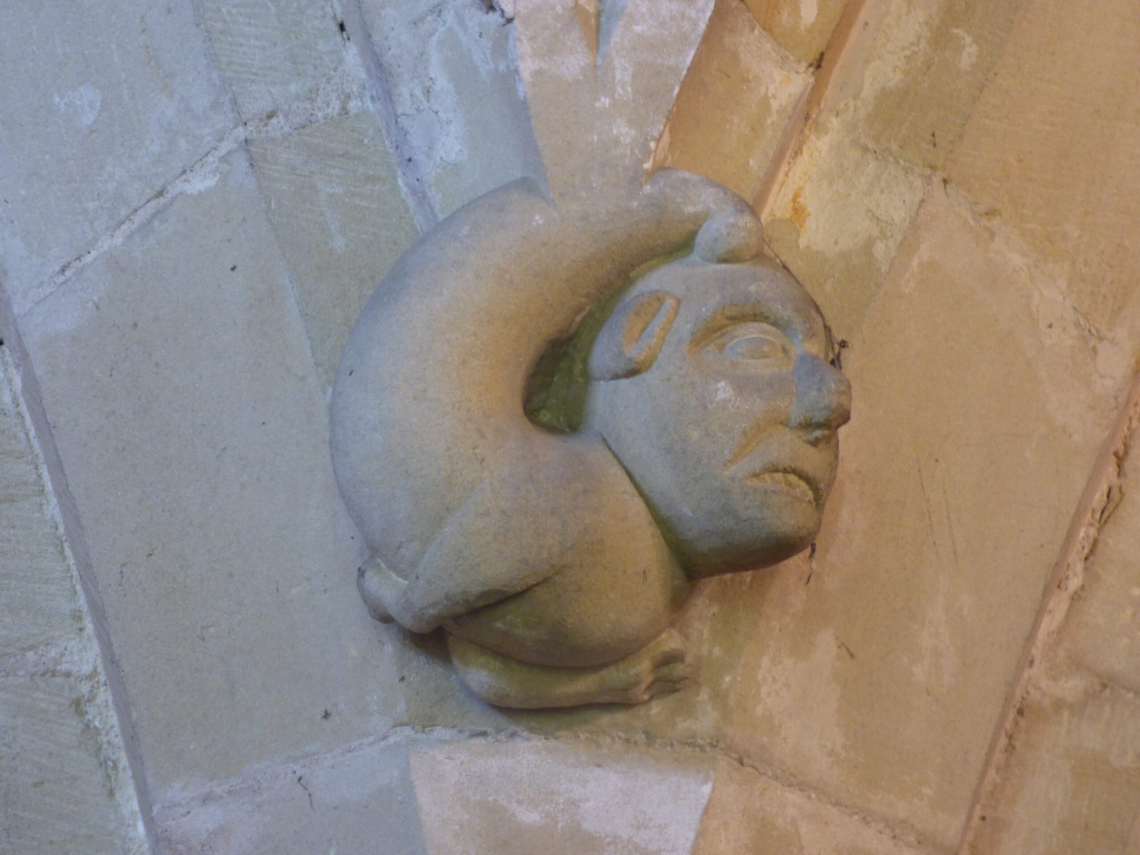 Carved archaic head from St Michael's Church, Kirklington