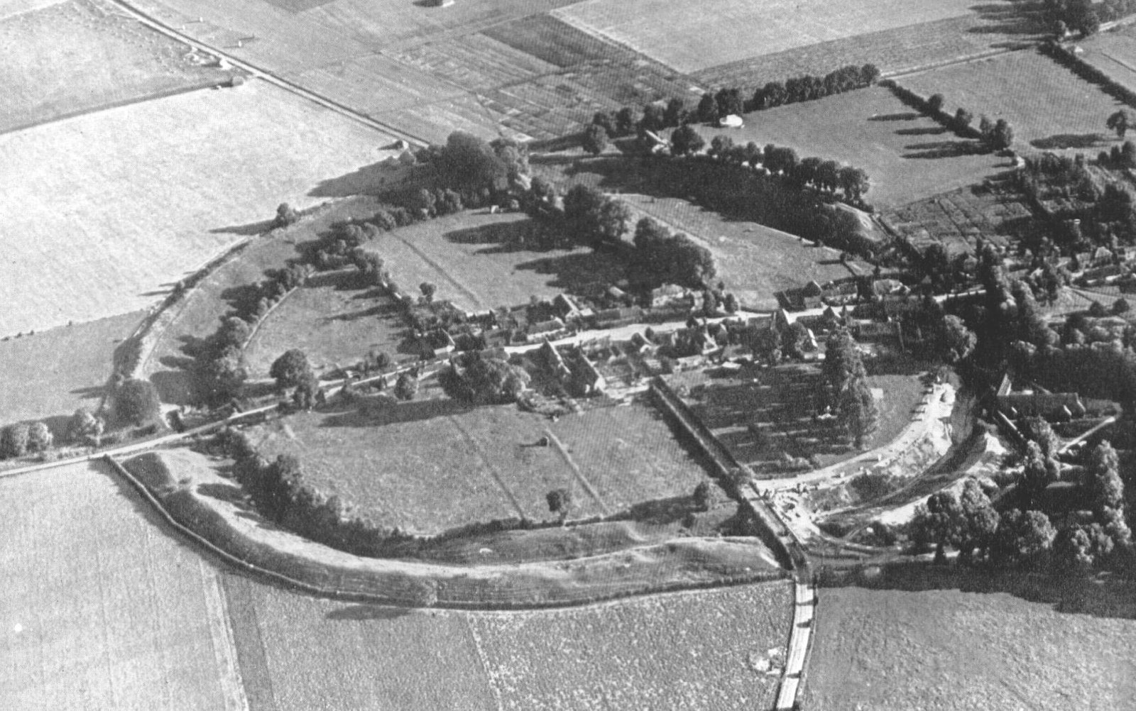 An aerial view of Avebury stone circle and henge. in monochrome, taken shortly after world war two.